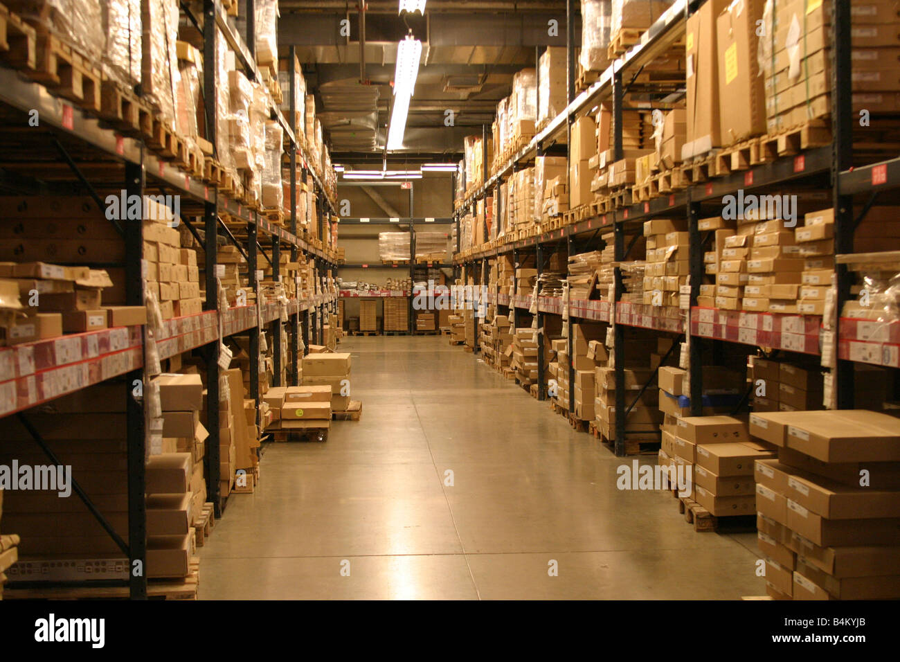 packages lining shelves in a warehouse Stock Photo