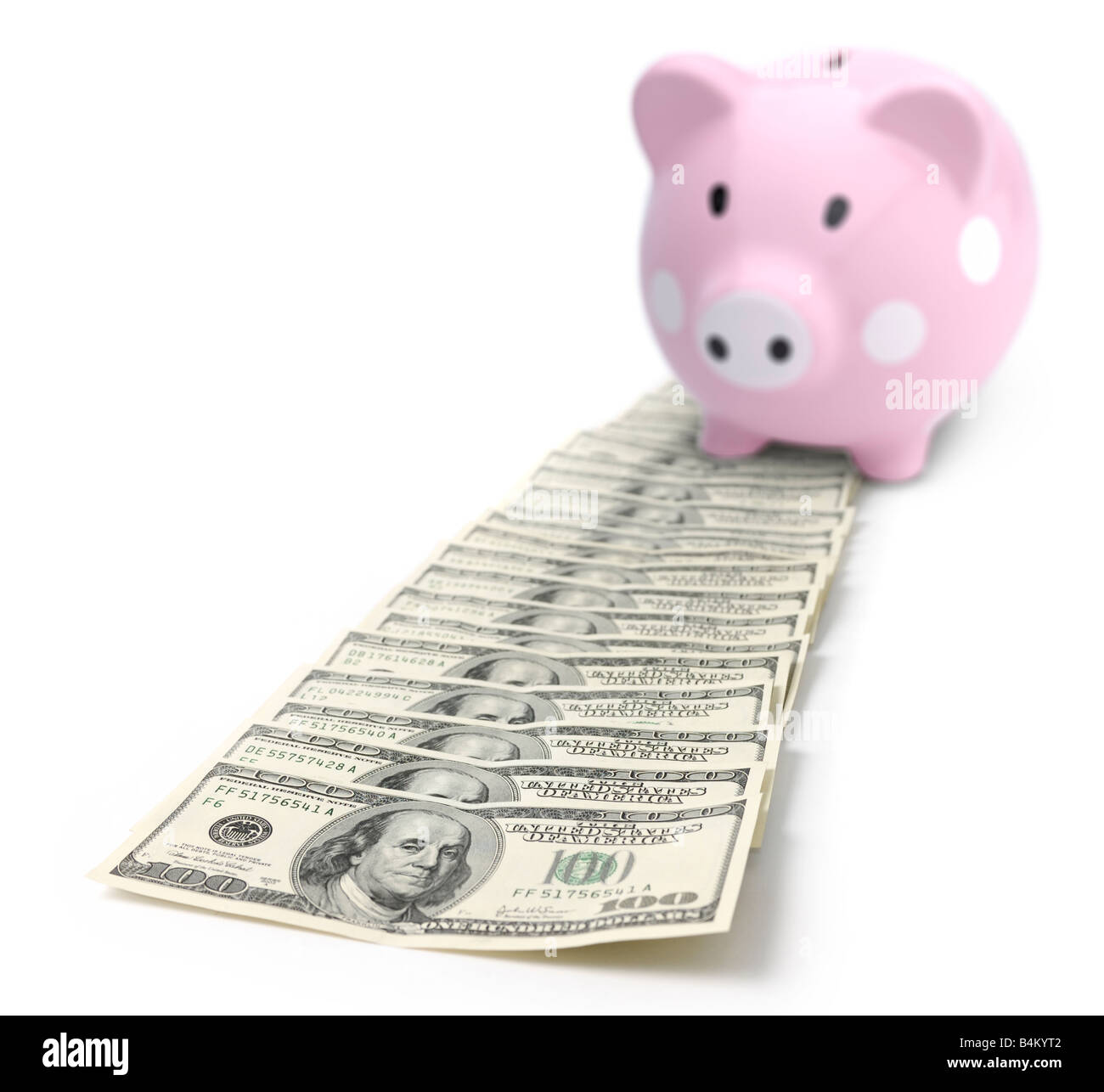 Piggy bank on a pile of money Stock Photo
