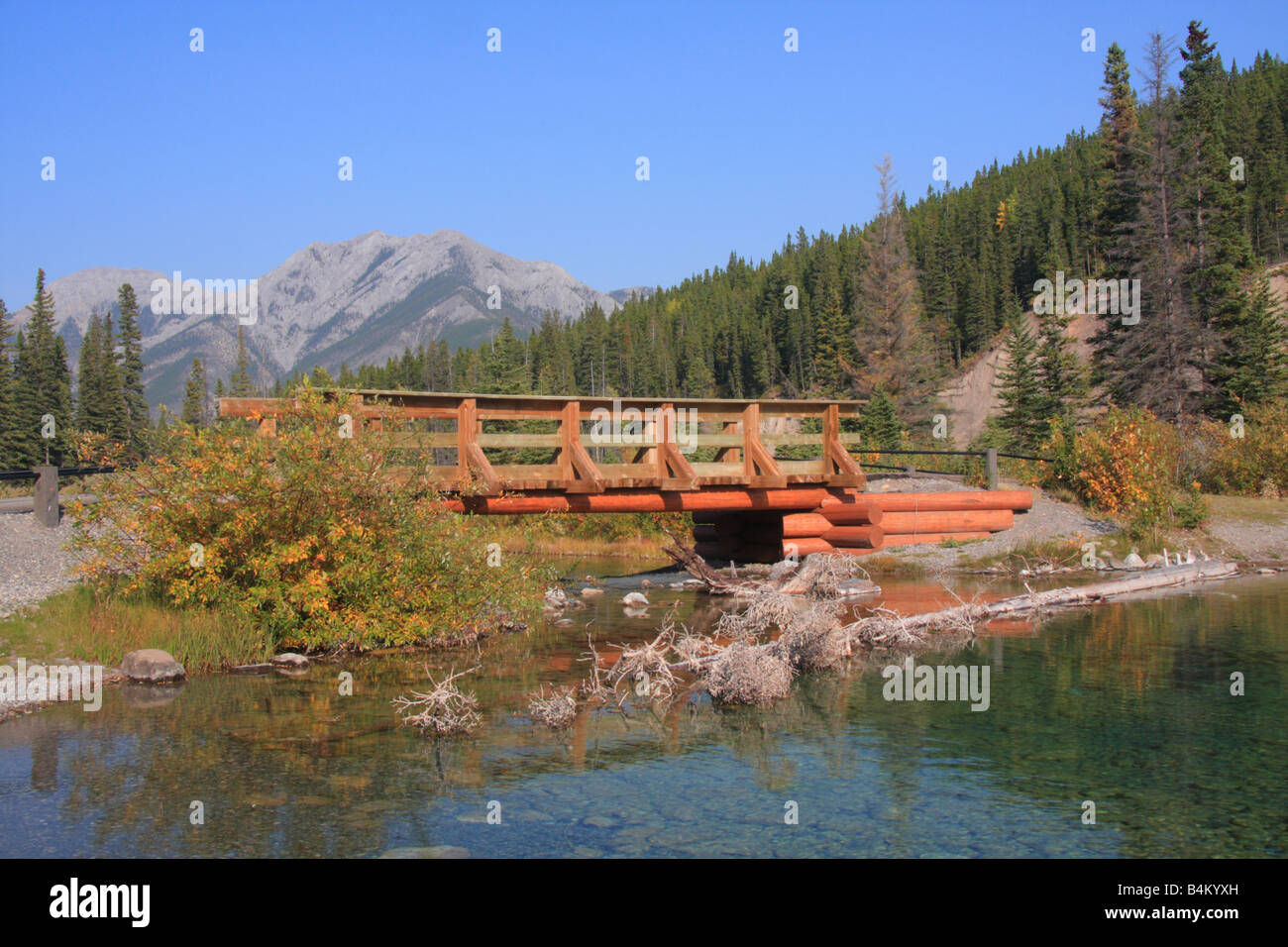 Wooden bridge above Mount Lorette pond, Kananaskis country, Alberta Stock Photo