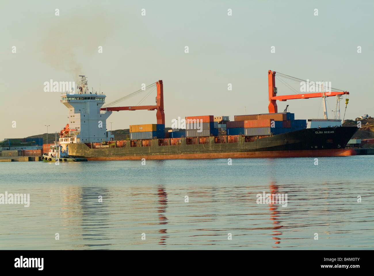 The Container Ship Clou Ocean Docking at Lavrion Harbour on the Greek Mainland in Early Morning Sunshine Stock Photo