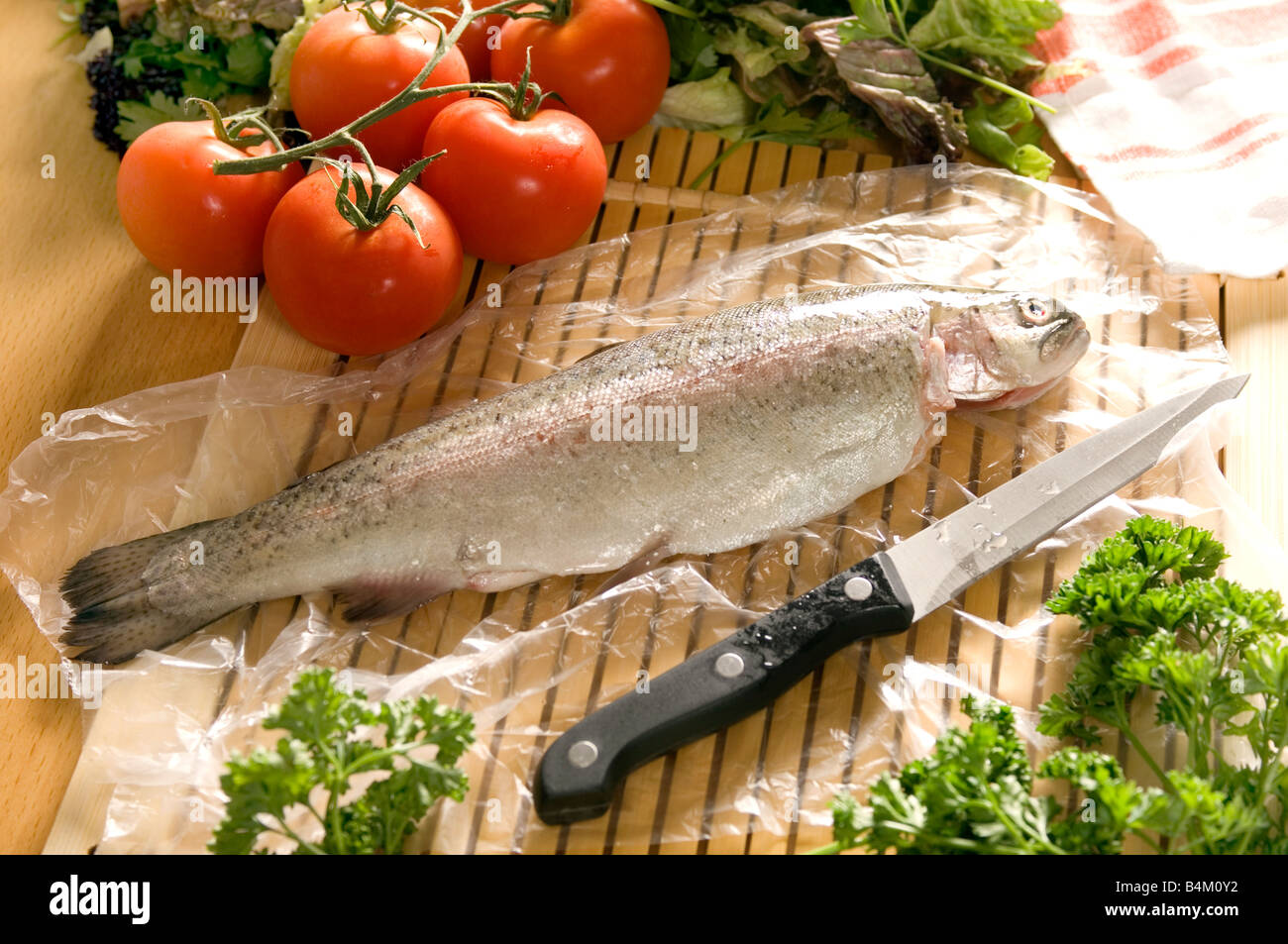 a fresh rainbow trout being prepared for cooking Stock Photo