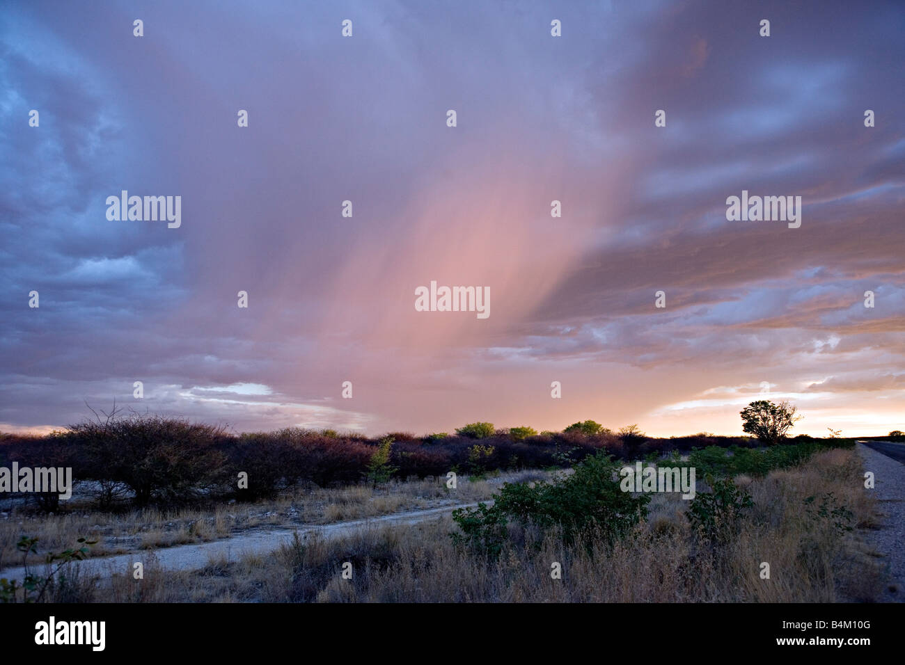 A scenic view of a distant clouds in the sunset in Oshikoto Region Namibia Stock Photo