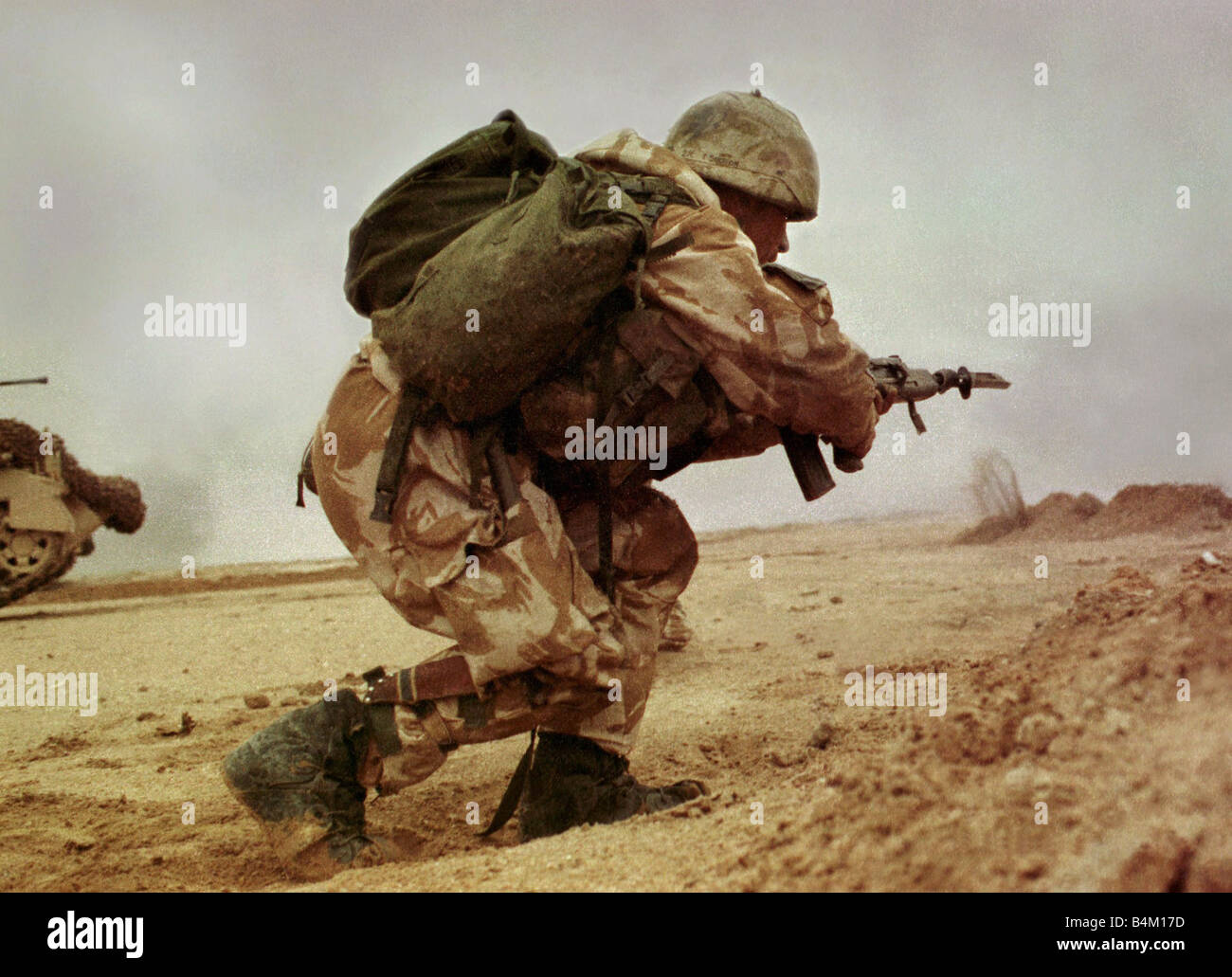 Gulf War British Army 1991 The only photographs showing ground troops in action 10 years ago in the Iraqi desert during the action to liberate Kuwait Mike Moore photographed Private Thomas Gow as Under fire Gow jumps up and runs forward across the mine strewn no mans land Crouching down Gow throws a grenade and destroys the enemy vehicle allowing the advance to continue Private Gow was awarded the Military Medal by the Queen for his bravery that morning Stock Photo