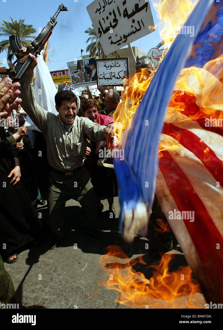 A Iraqi government sponsored Anti American demonstration on a Baghdad street prior to the US led invasion Our Picture Shows Protesters burn the American Stars and Stripes flag Stock Photo