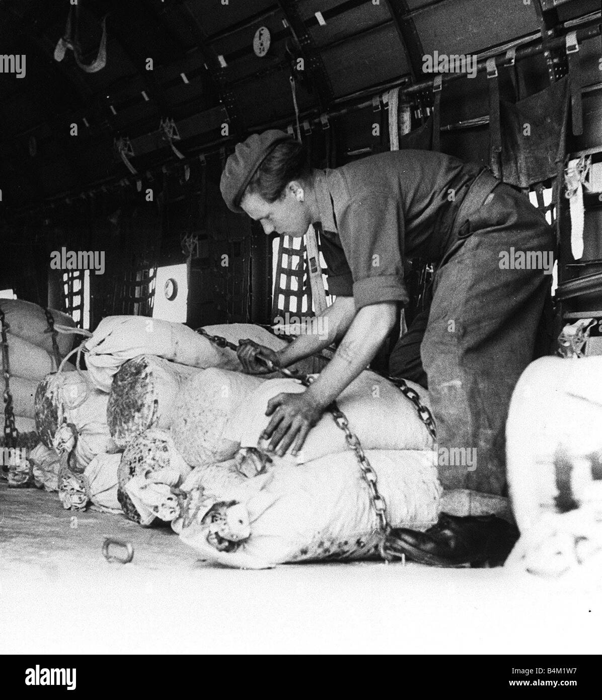 Berlin Air Lift 1948 A British soldier helps load goods onto a Dakota aircraft bound for stricken West Berlin The Allied powers Stock Photo