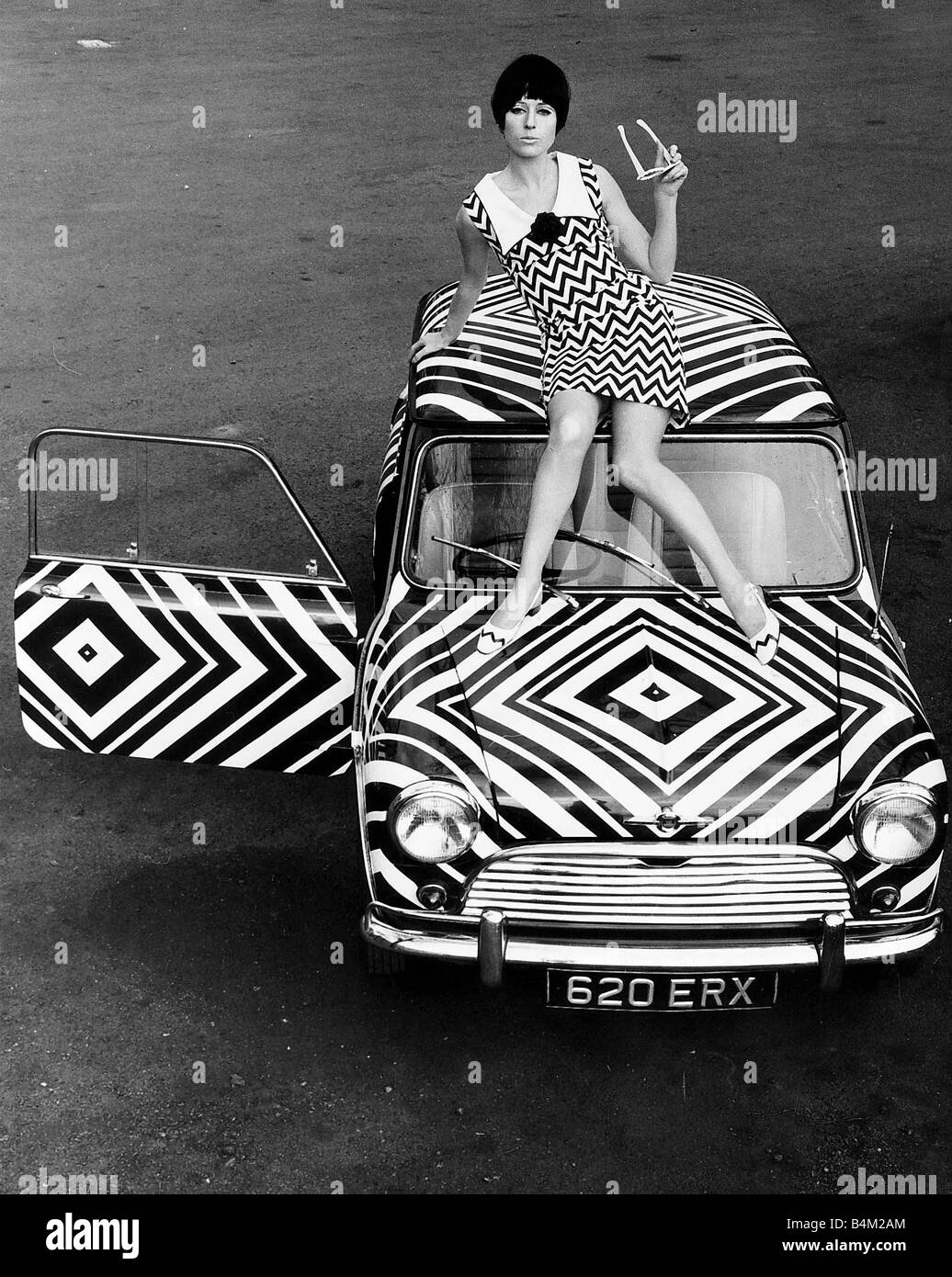 The Mini motorcar March 1966 that has received the Op Art treatment from an amateur with a pair of scissors about a quarter of a mile of of stick on plastic and plenty of time and patience The car is for sale in Thames Ditton Surrey and costs 385 Cars Mini Clothing Fashion Dress Transport Car March 1966 1960s Stock Photo