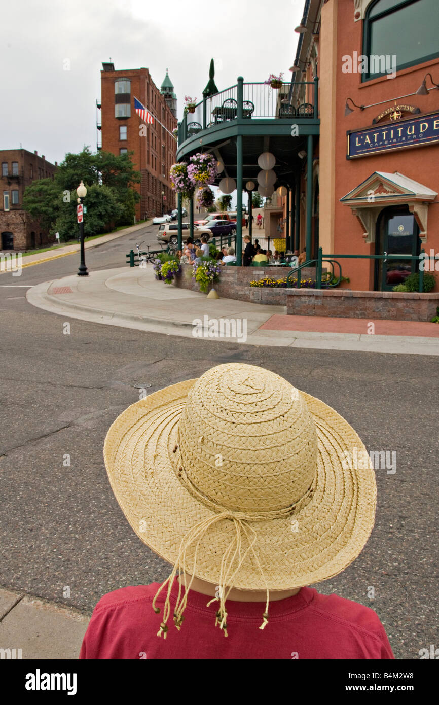 A lady in a sunhat in downtown Marquette Michigan Stock Photo