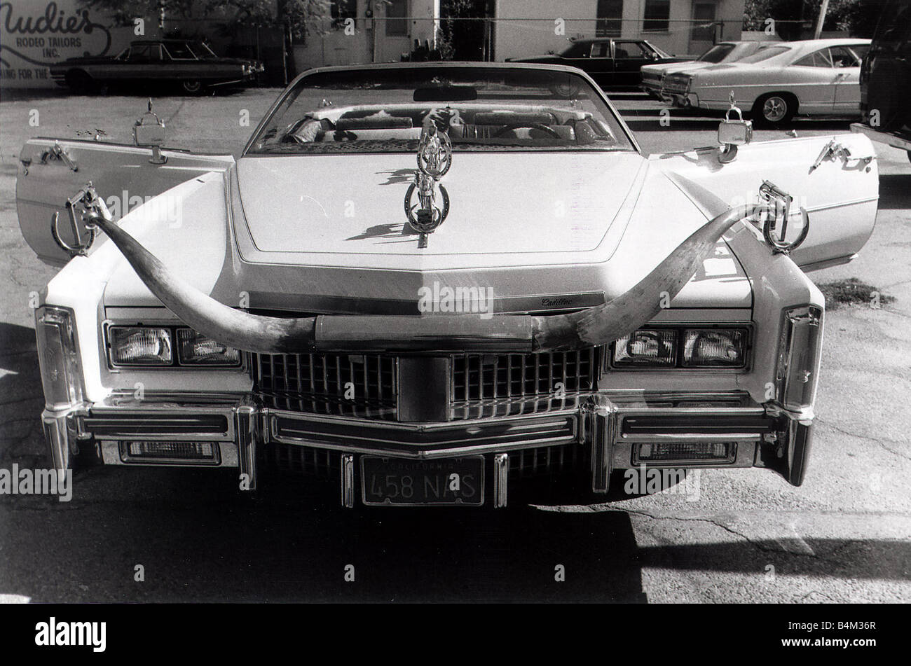 Cadillac Eldorado Convertible car Nudie the man who supplies clothes to the likes of John Wayne has turned his car in to a cowboyÍs tribute On the grill he has attached a pair of Longhorns Cow horns Horse shoes Guns Pistols Colt 45 s Stock Photo