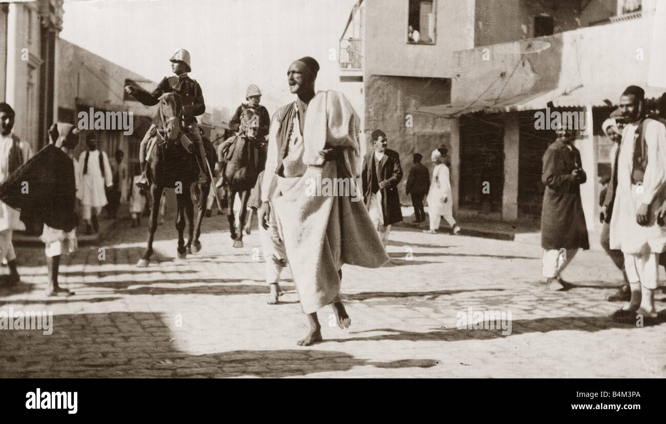 Turco Italian War An Arab town crier under italian escort seen here announcing to everyone that the curfew begins at eight o clock November 1911 Stock Photo