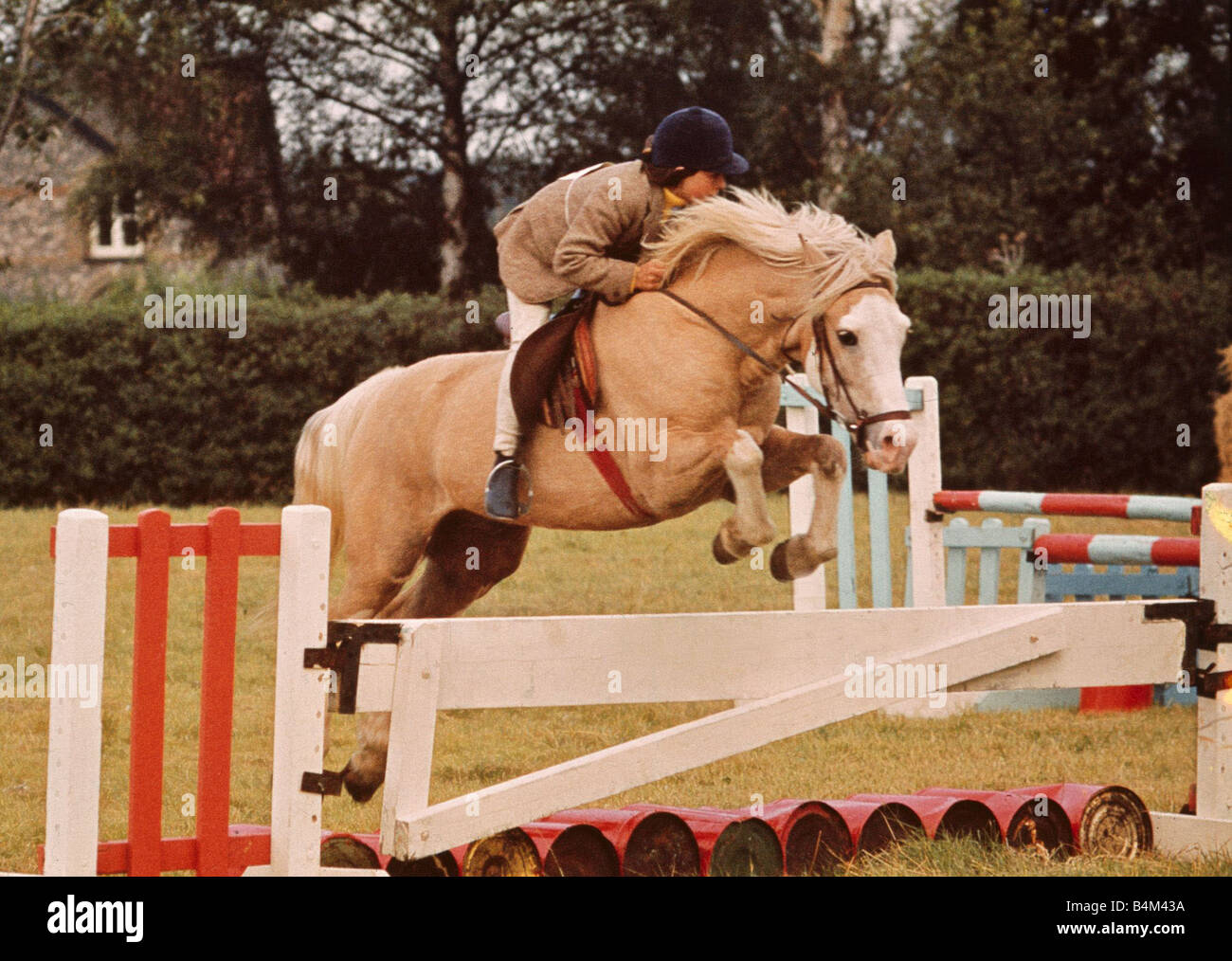 A girl rides hers horse over one of the jumps during Gymkhana at