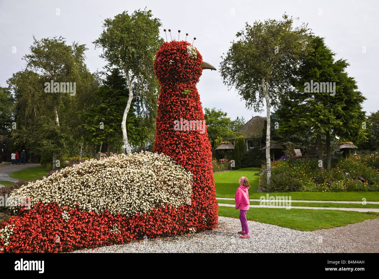 Small child dwarfed by huge floral display at Jesperhus flower park, Nykøbing, Denmark Stock Photo