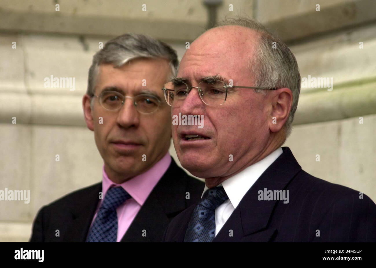 Australian Prime Minister John Howard R March 2002 holds a news conference with Britain s Foreign Secretary Jack Straw The Commonwealth has saved its reputation by taking a tough line against Zimbabwe Howard said His meeting with Nigerian President Olusegun Obasanjo and South African President Thabo Mbeki had been widely expected to delay any action against Zimbabwean President Robert Mugabe whose controversial re election last week had split the group of 54 mainly former British colonies down racial lines Stock Photo