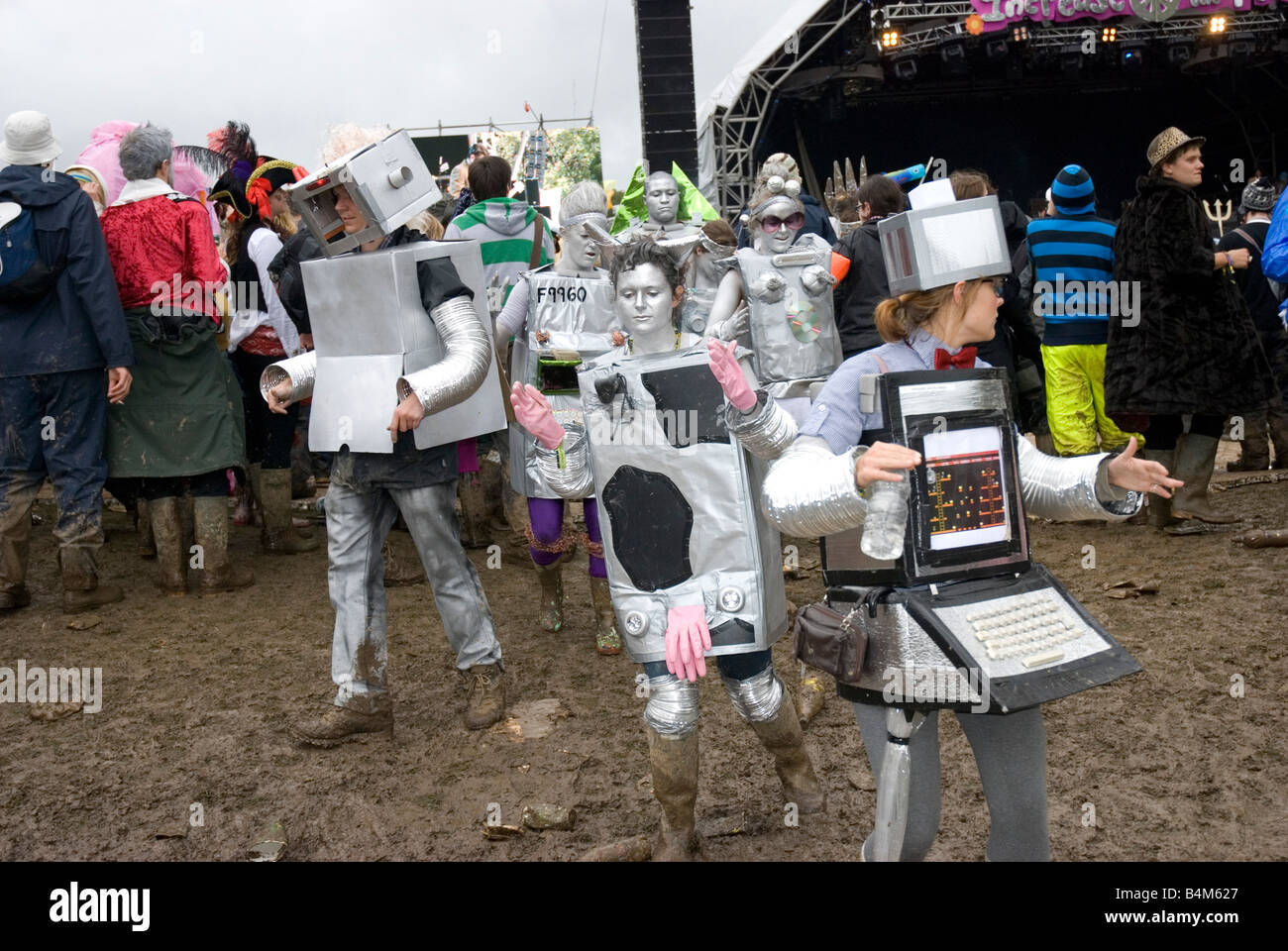 Group of people dressed up as a computer machine, walking in a mud, Bestival , Isle of wight UK 2008 Stock Photo