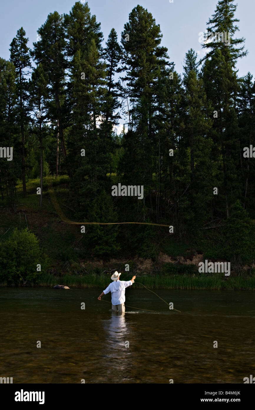 A fly fisherman casts while fishing the Blackfoot River in Montana. Stock Photo