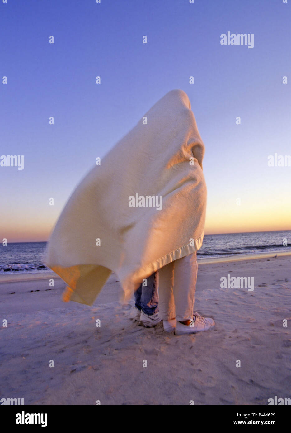 Couple Under Blanket Stock Photo - Alamy