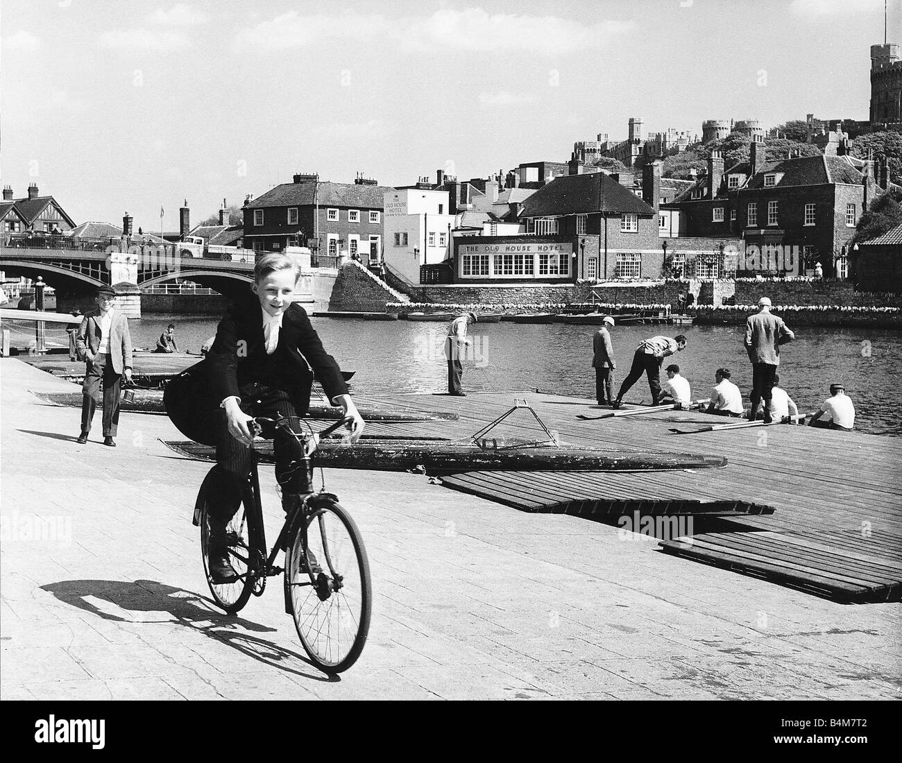 Eton schoolboy cycling along the Thames in his school uniform Circa 1970 Stock Photo