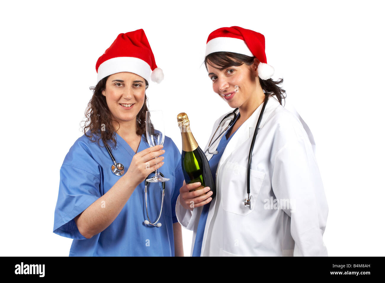 Friendly female doctors with christmas hat and champagne bottle Stock Photo Alamy