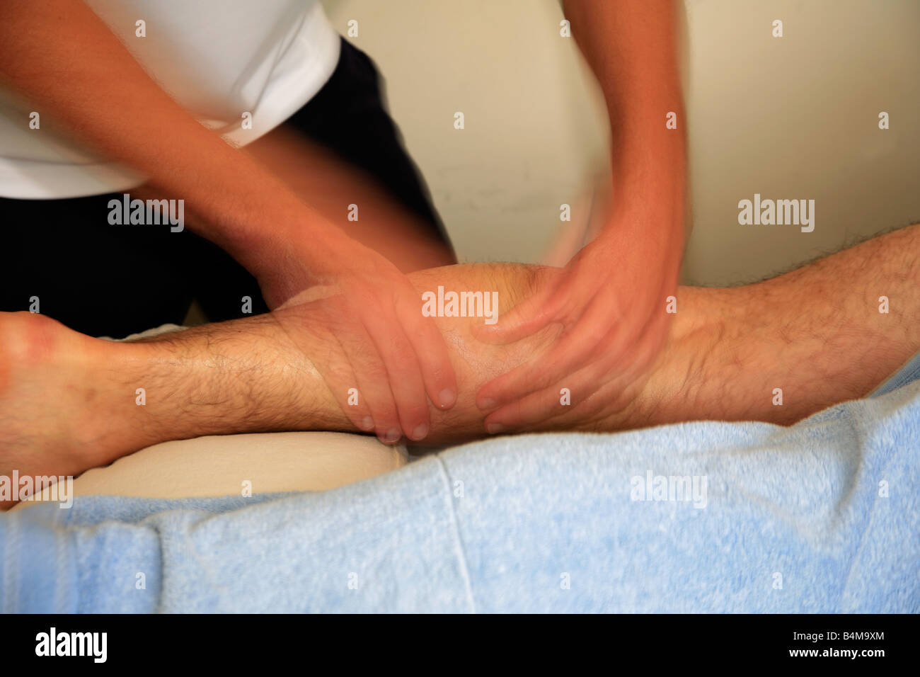 Sports Physiotherapy Massage on a males injured calf muscle Stock Photo