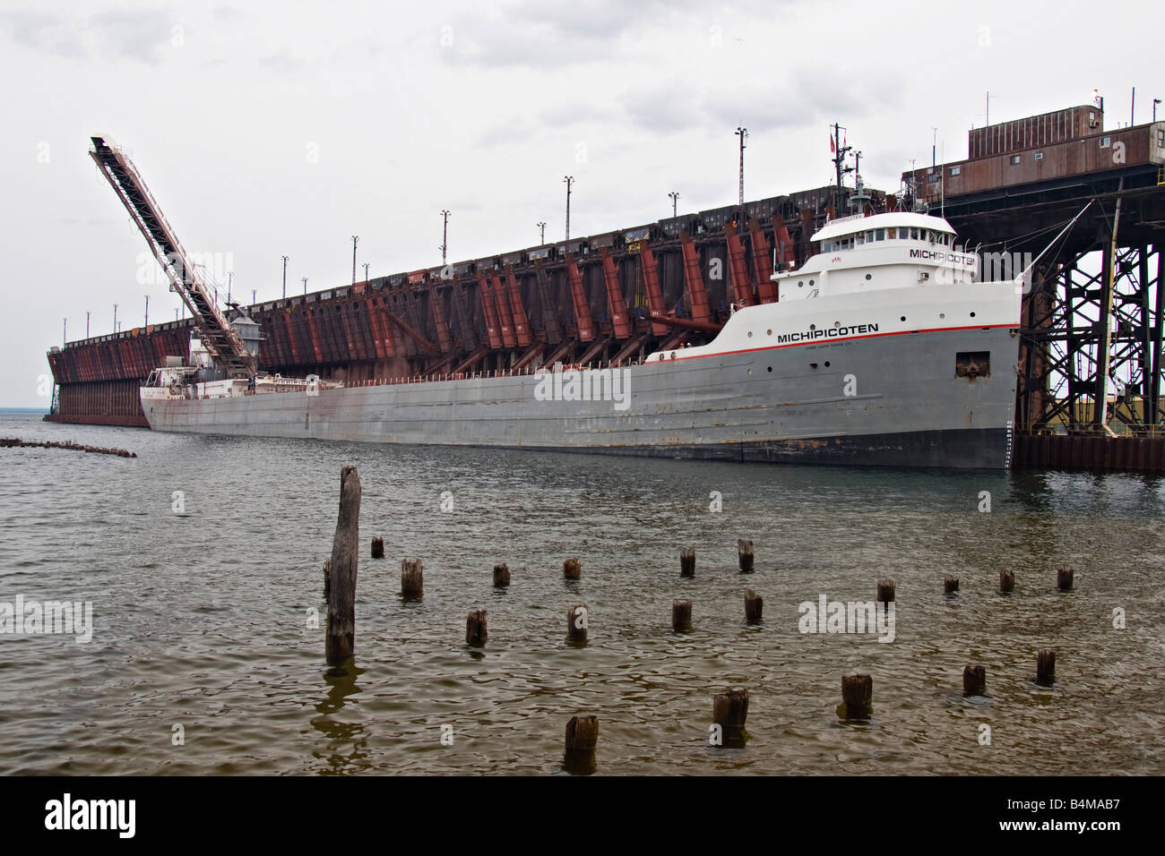 The Great Lakes freighter Michipicoten loads iron ore at the ore dock in Marquette Michigan Stock Photo