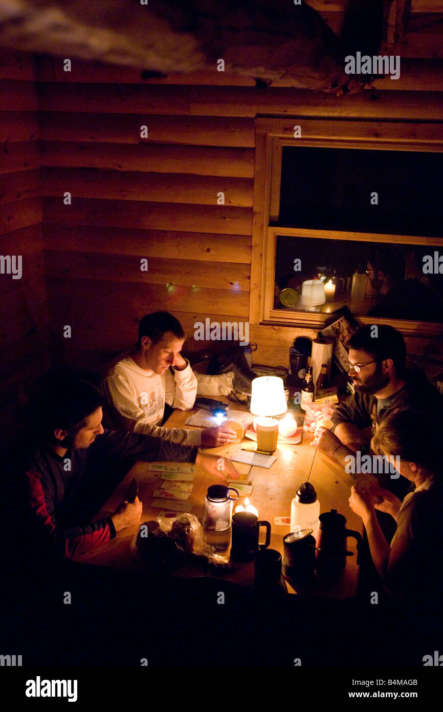 A Group Of Friends Play Games While Staying In A Rustic Cabin In