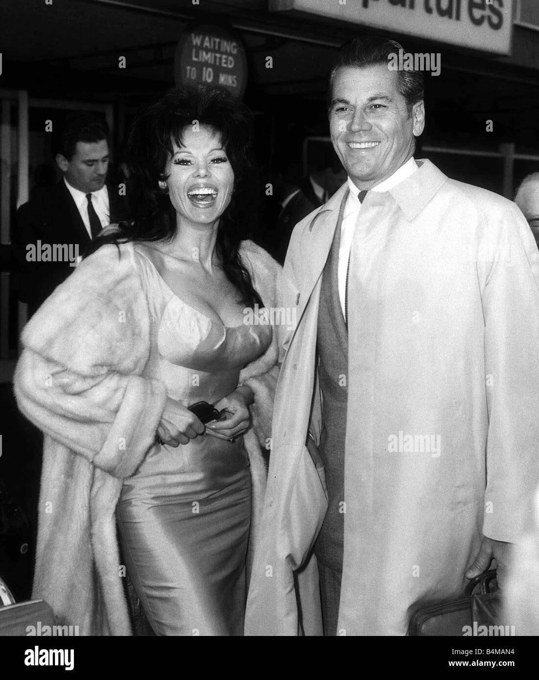Laya Raki Actress May 1965 and husband Ron Randell at London Airport Stock Photo