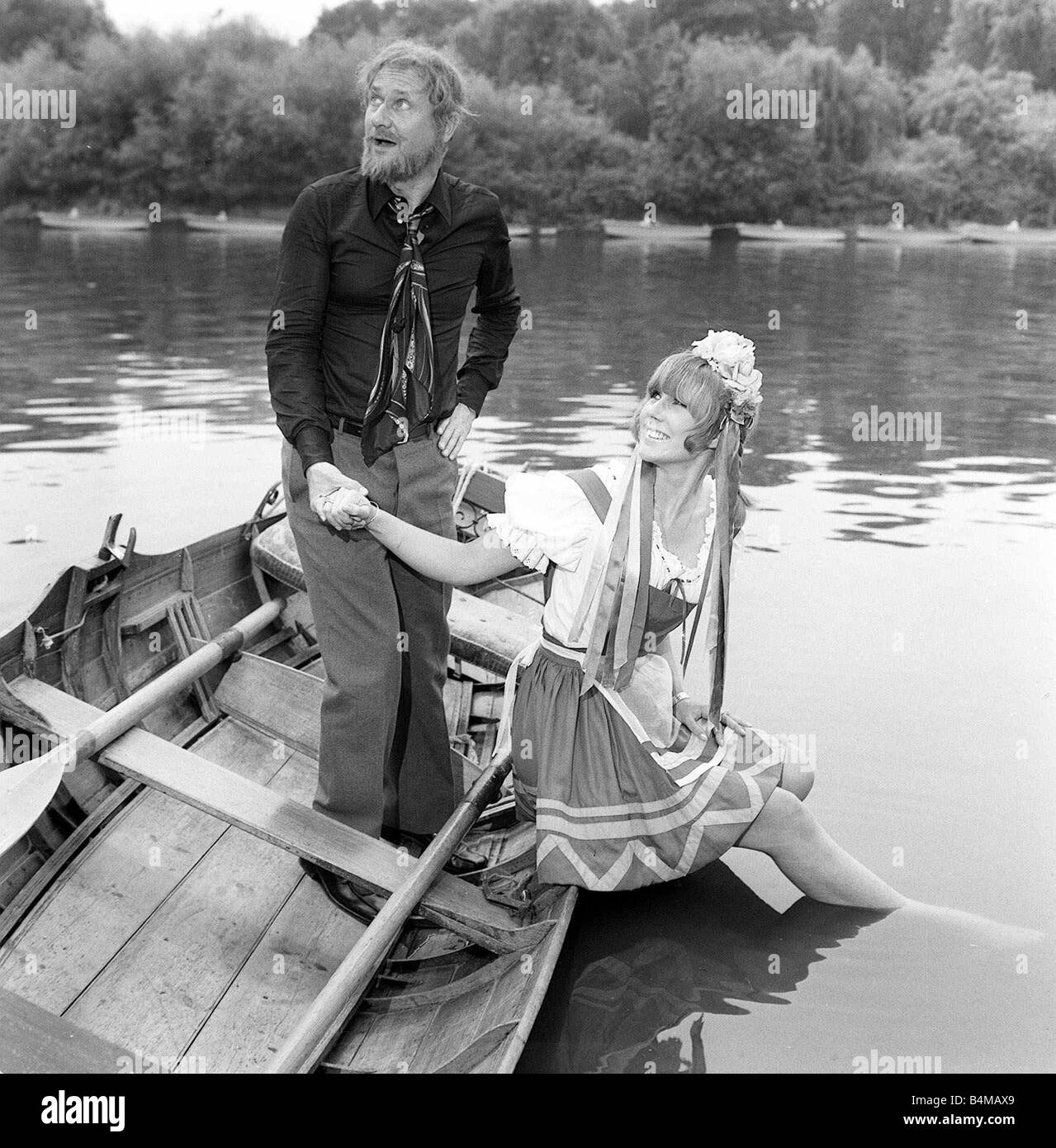 Donald Pleasence July 1969 actor holds the hand of actress Carol Wilson 23 while she cools her feet in the river Stock Photo