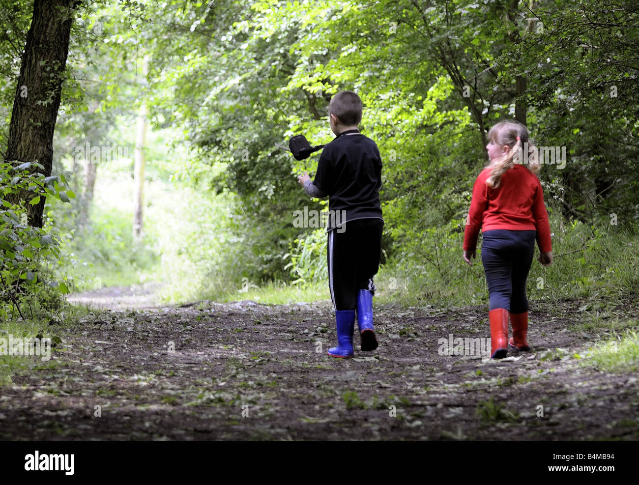 A brother and sister playing in the woods Stock Photo - Alamy