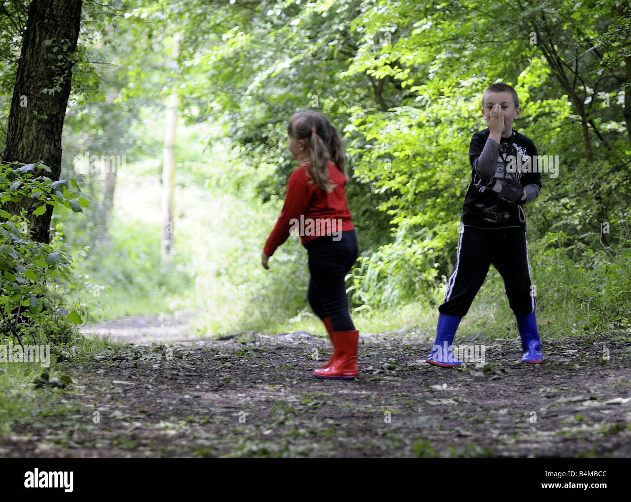 A brother and sister playing in the woods Stock Photo - Alamy