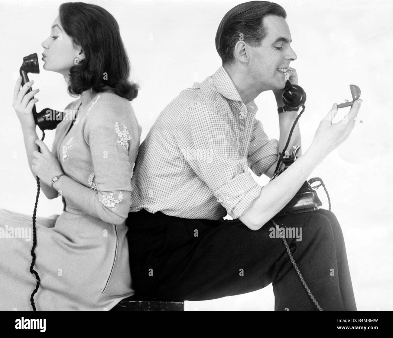 Ian Carmichael and Janette Scott on the telephone he is holding the wedding rings Stock Photo