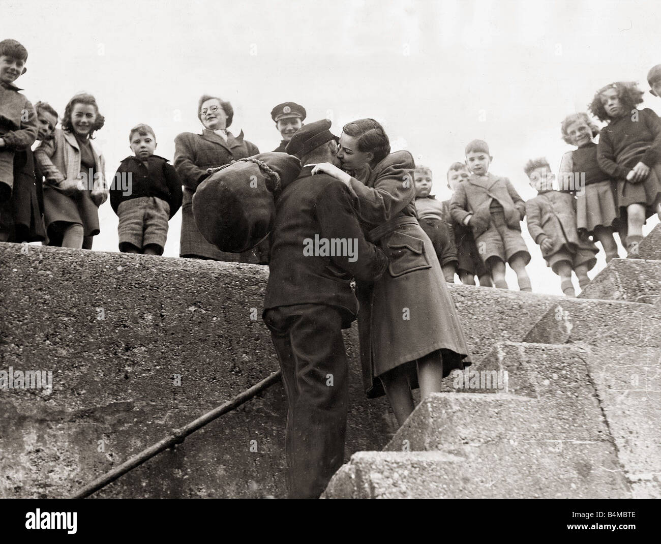 Lighthouse worker John Mcleod is greated by his wife after 77 days confined in the lighthouse
