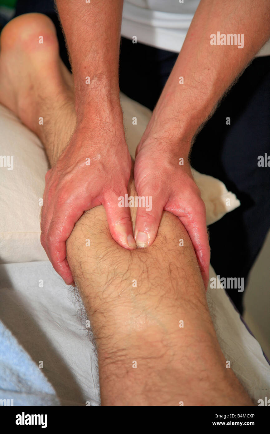 Sports Physiotherapy Massage on a males injured calf muscle Stock Photo