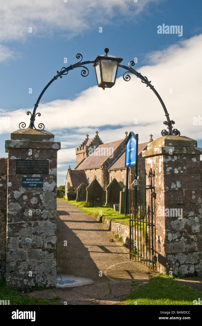 Llanmadoc Church in Gower South Wales through the arch of the churchyard gateway archway. Stock Photo