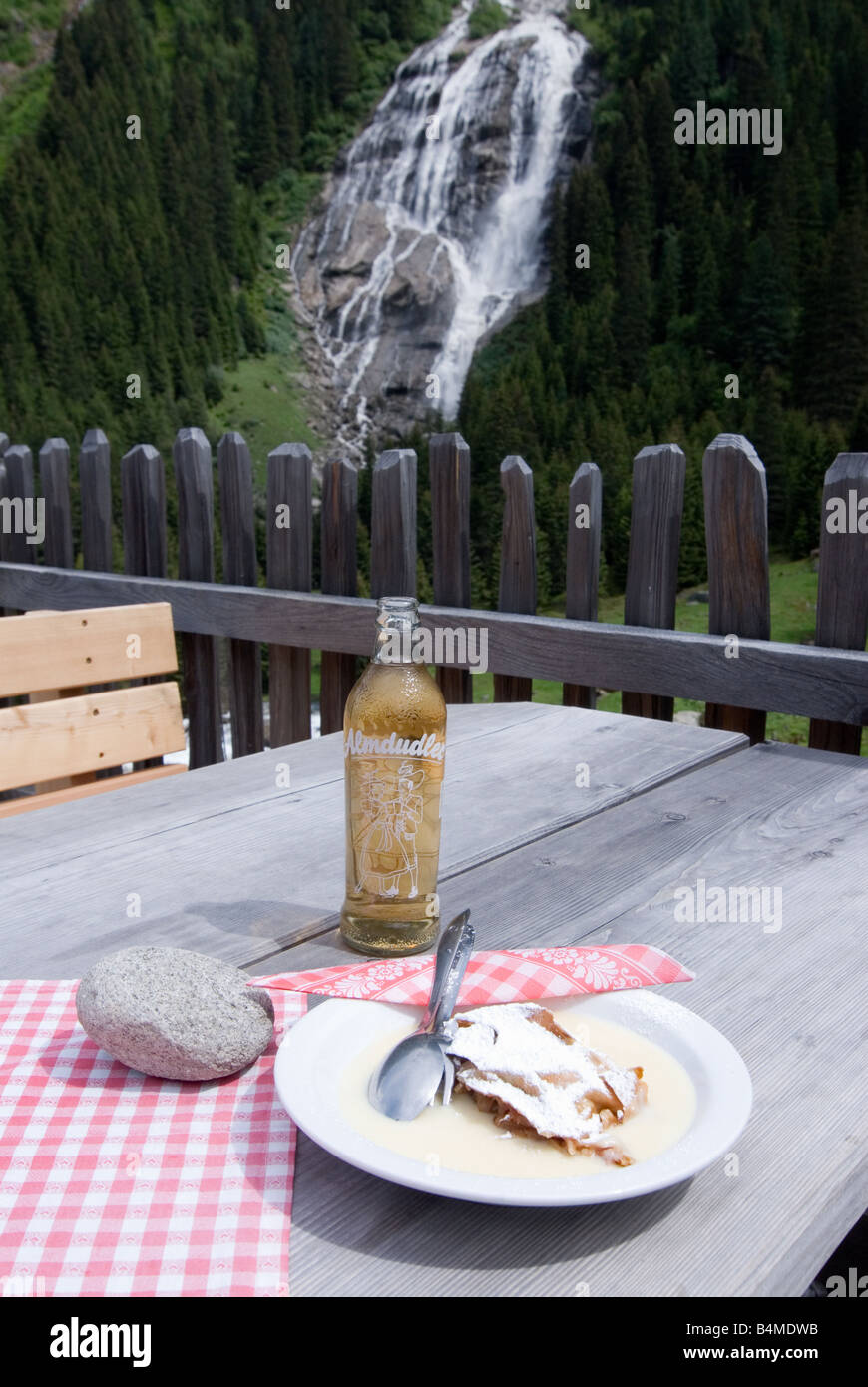 Apple strudel with vanilla sauce and Almdudler lemonade at Grawa Waterfall in Stubaital Valley Tyrol Austria Stock Photo