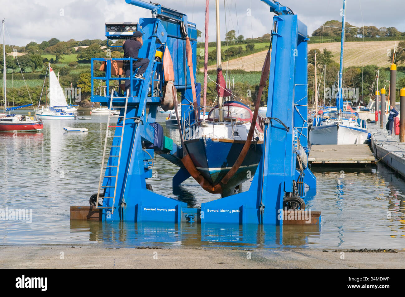Sailing Yacht being hauled on sling up a slipway on the River Fal, Falmouth, Cornwall Stock Photo