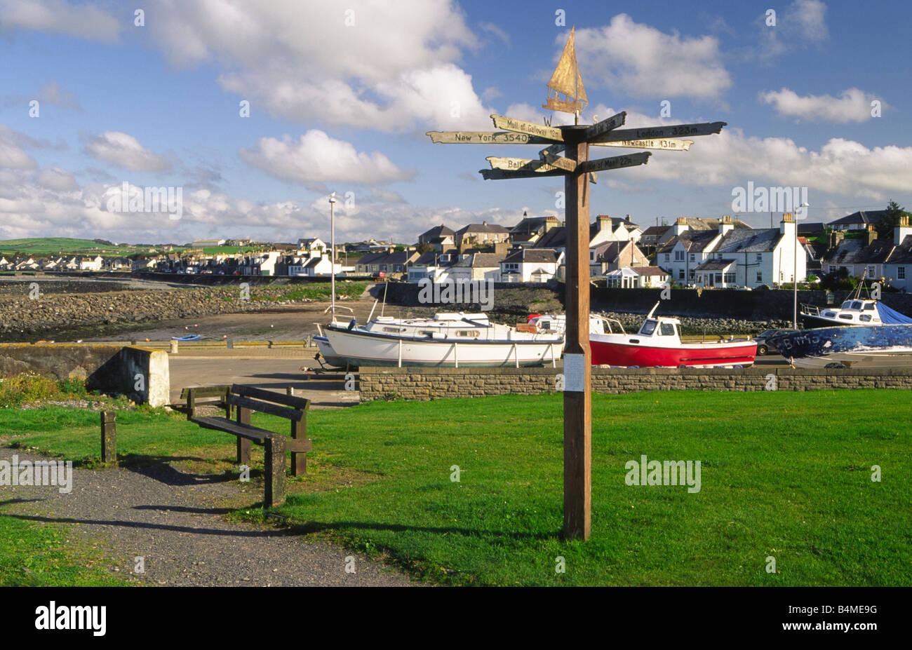 Port William harbour on the edge of Luce Bay in the Machars of Galloway coast direction and distance sign post Scotland UK Stock Photo