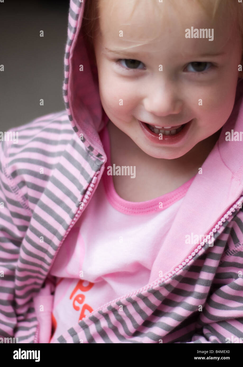 portrait of toddler girl in hooded top looking at camera Stock Photo
