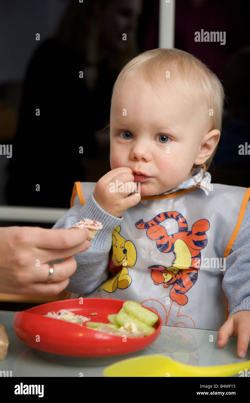 Child wearing bib while eating hires stock photography and images Alamy