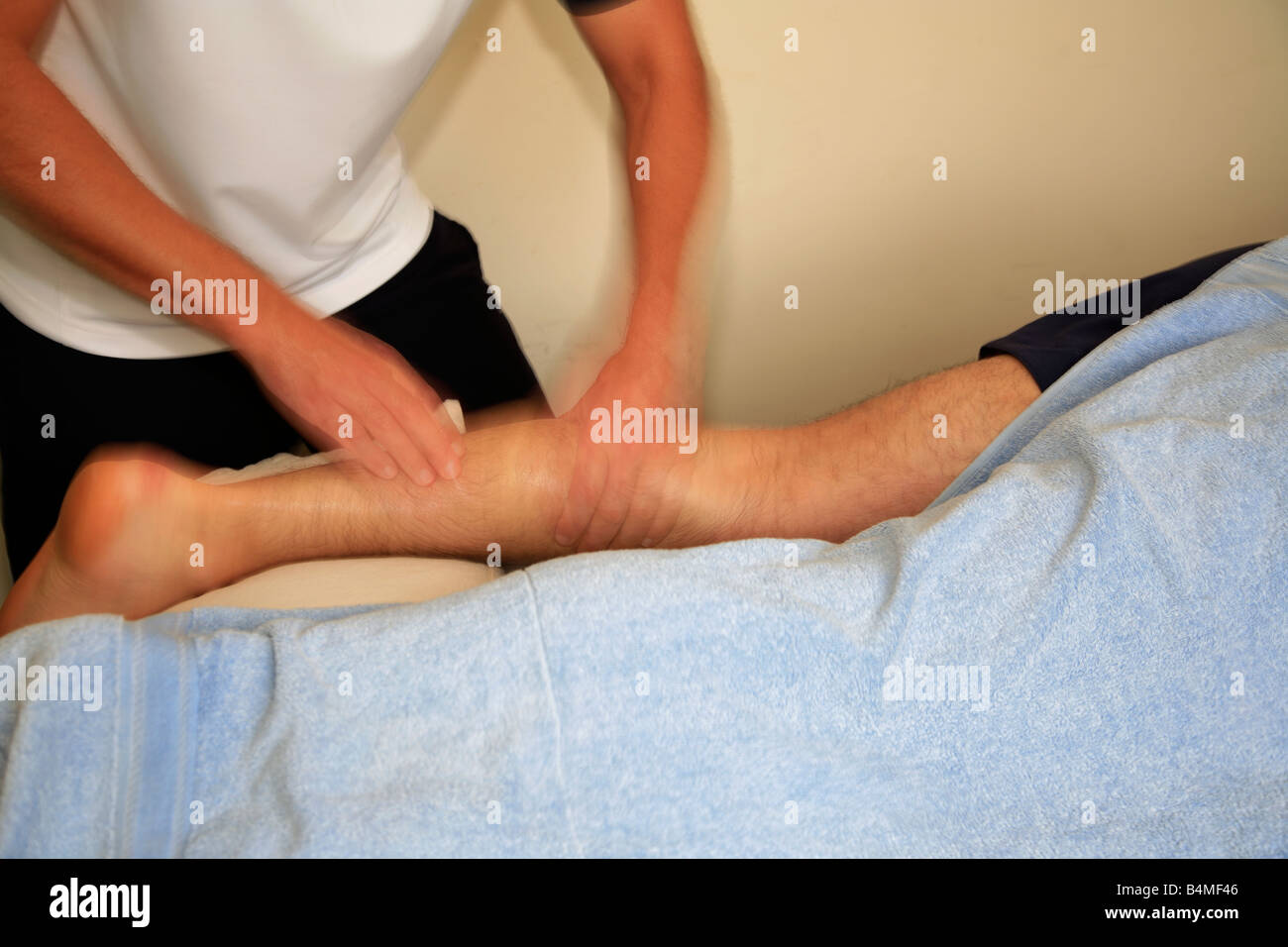 Sports Physiotherapy Massage on a males injured calf muscle Stock Photo