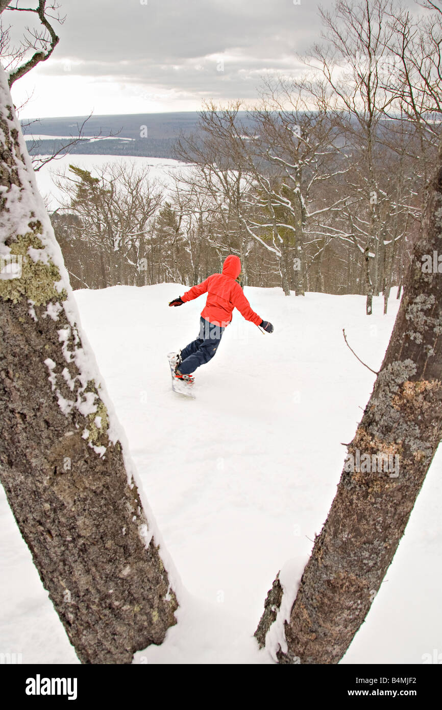 A snowboarder in the extreme backcountry section of Mount Bohemia ski resort in Michigans Upper Peninsula Stock Photo