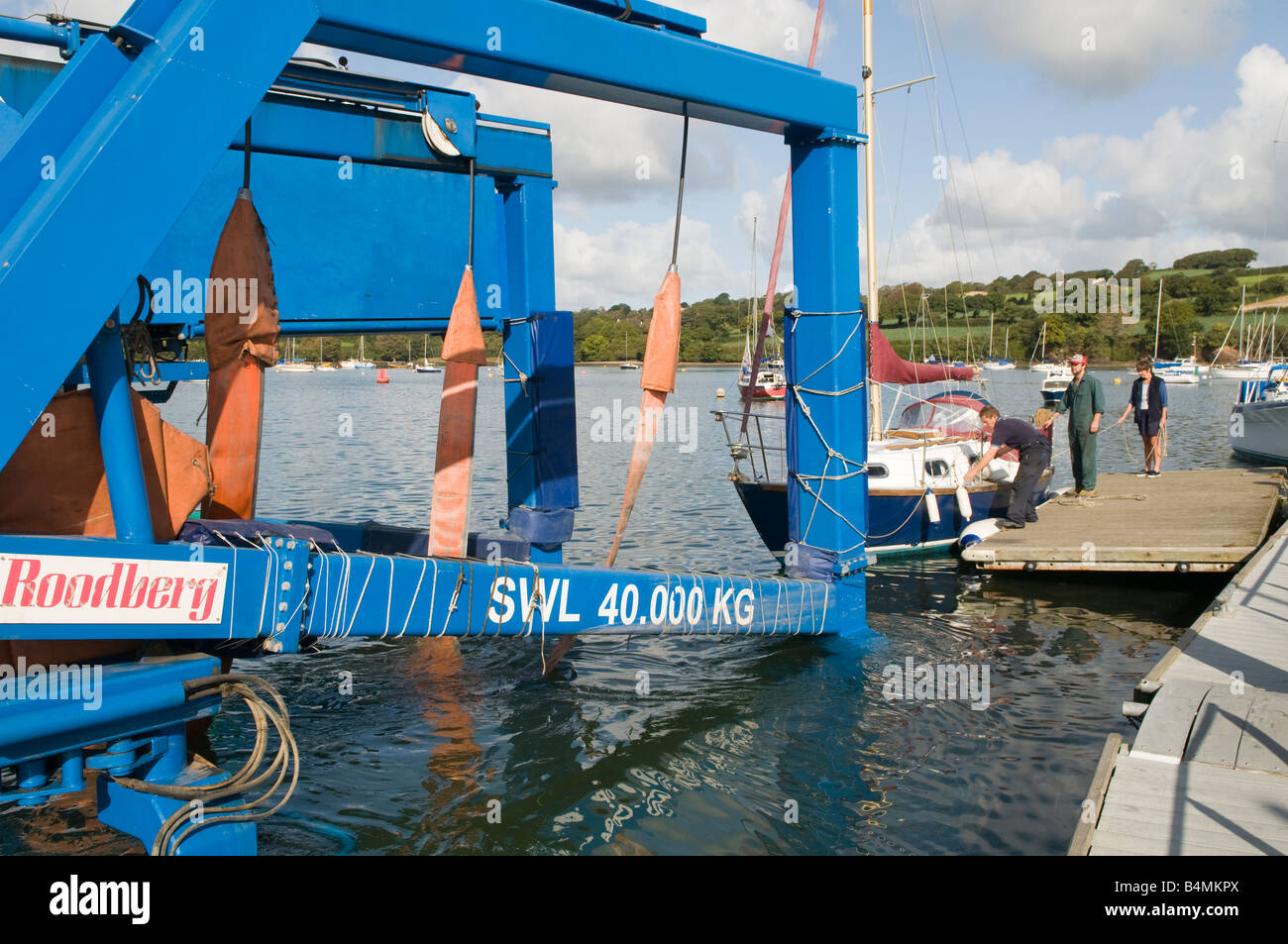 Sailing Yacht being hauled on sling up a slipway on the River Fal, Falmouth, Cornwall Stock Photo