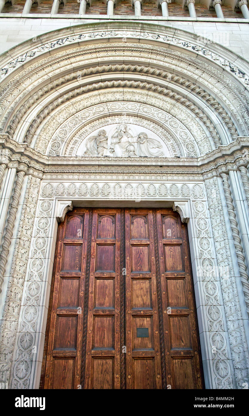 A large carved wood door and the ornate marble threshold of Church