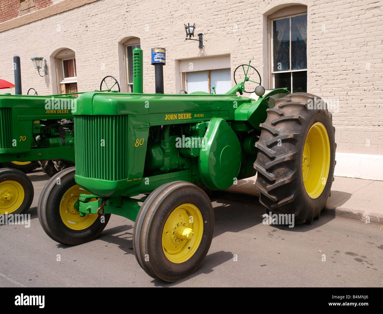 John Deere Model 80 Tractor together with other classic tractors decked out for the 4th July Parade Williams AZ US Stock Photo