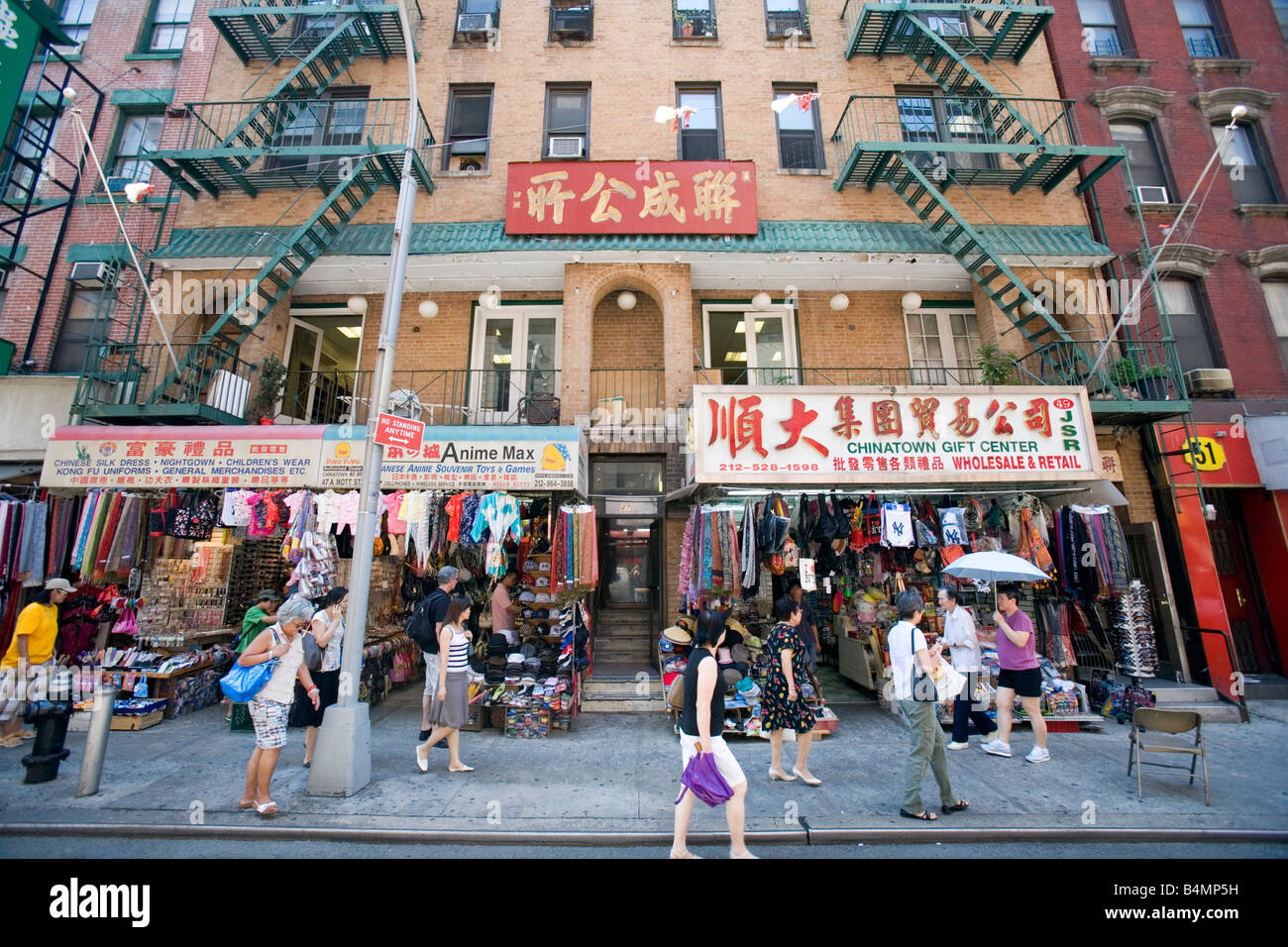 Pedestrians walk on street in Chinatown New York City. Stock Photo