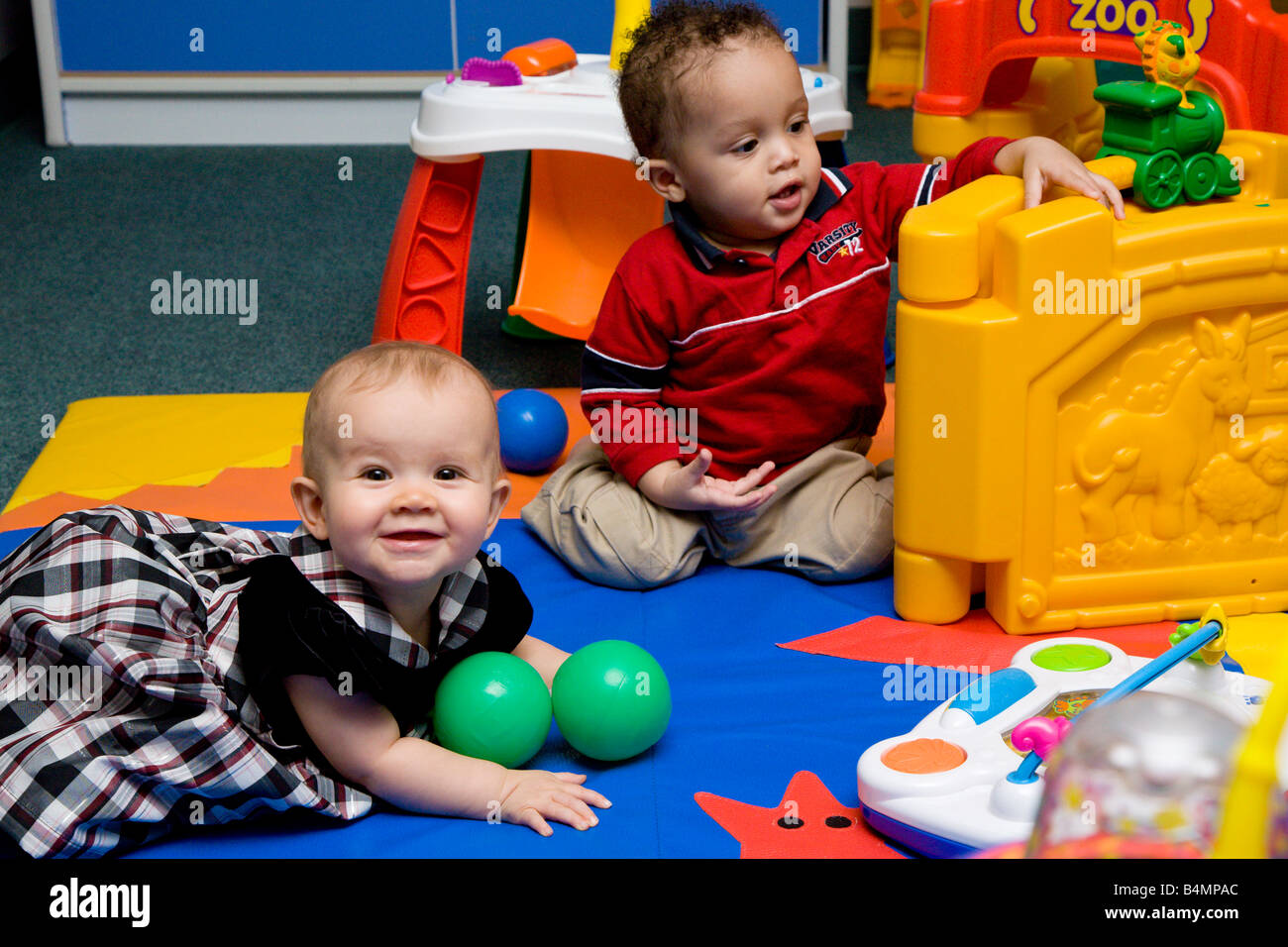 Toddlers play with toys in daycare facility Stock Photo Alamy