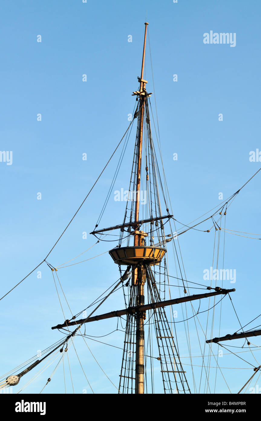 Upper mast and spars of the Mayflower 2 against blue sky in Plymouth Harbor, MA with rigging and crows nest. USA Stock Photo