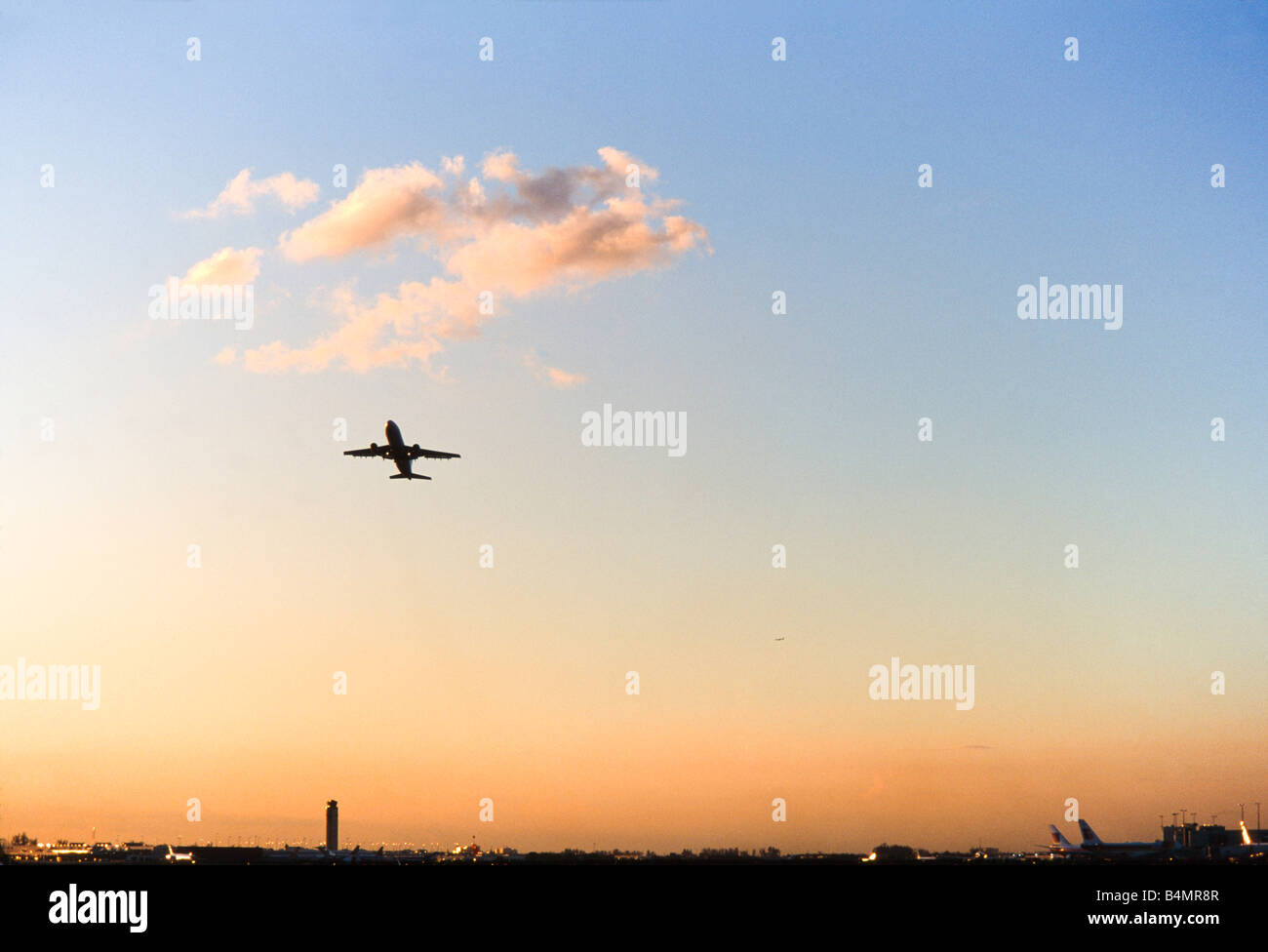 Commercial Airliner taking off, dramatic cloud filled skies. Stock Photo