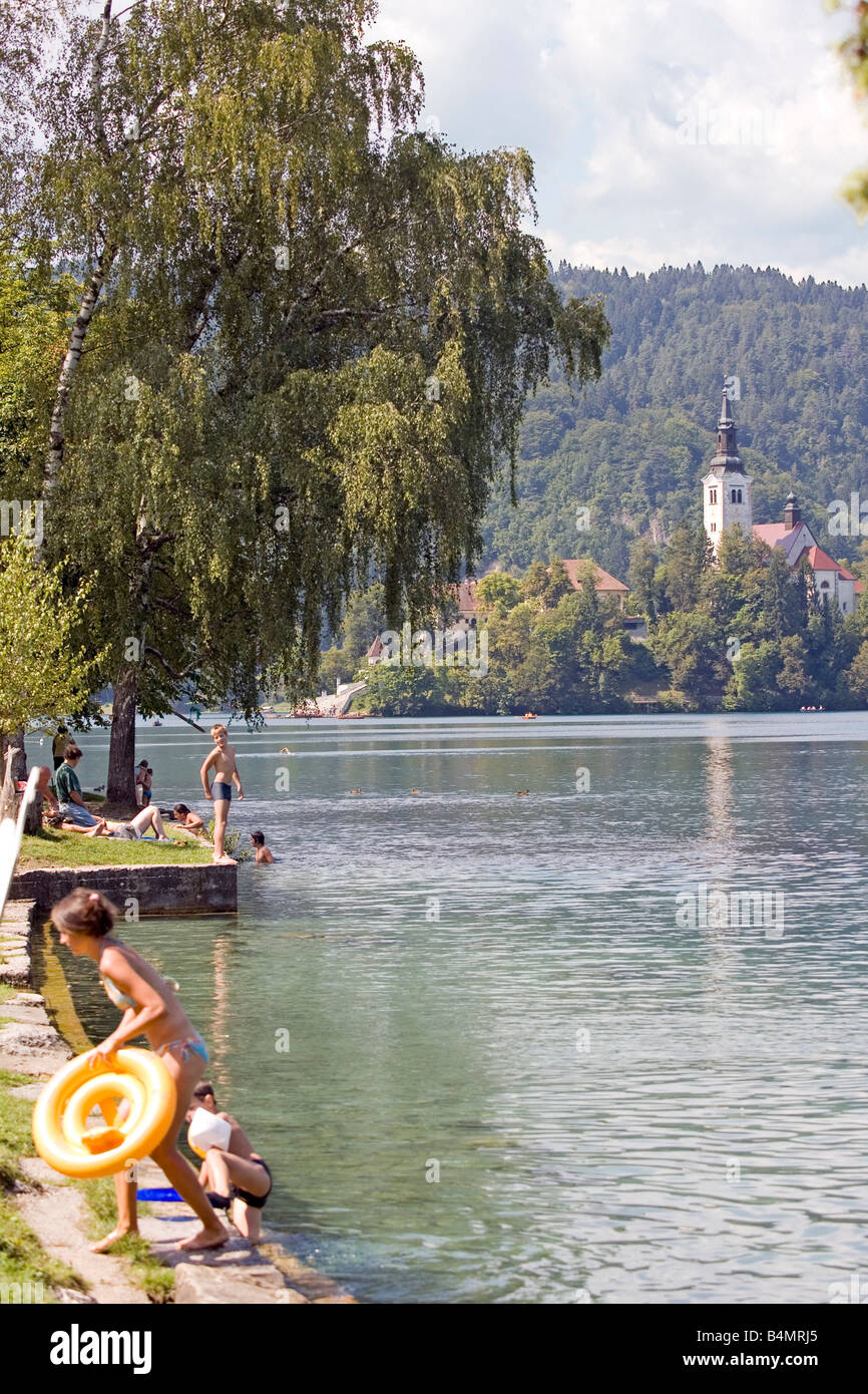 Lake Bled Republic of Slovenia People bathing in the lake with a well known landmark Church of the Assumption Stock Photo