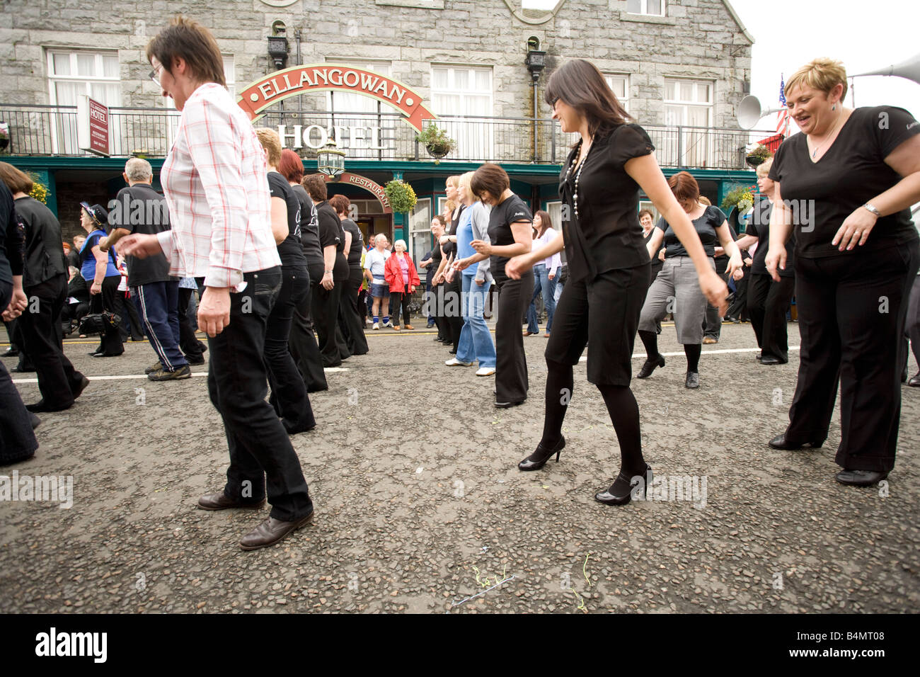 Line dancing on the street at Creetown Country Music Festival which is part of Gaelforce arts and entertainment festival UK Stock Photo