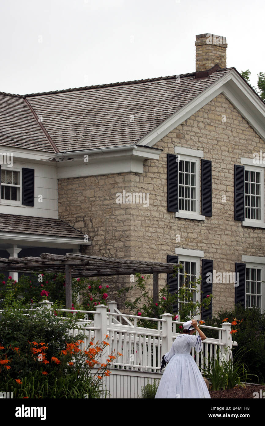 A living museum house and participant walking at the Old Falls Village