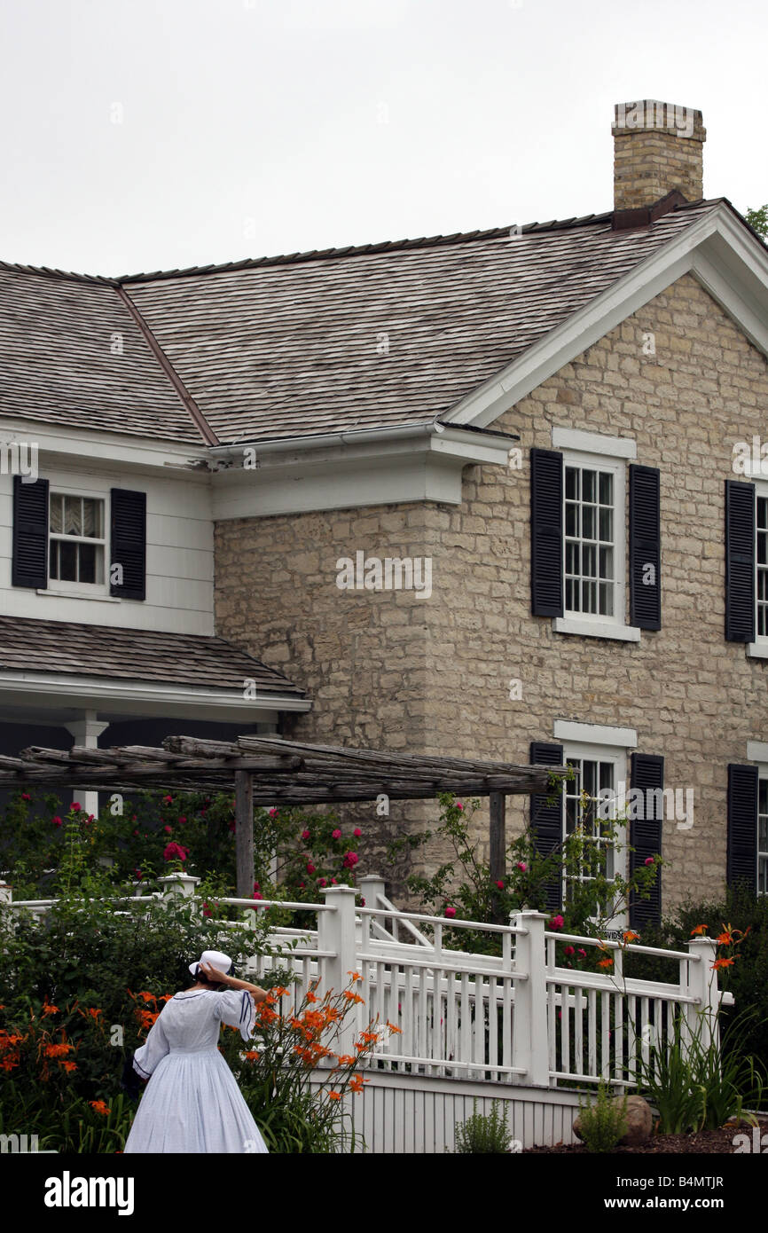 A living museum house and participant walking at the Old Falls Village
